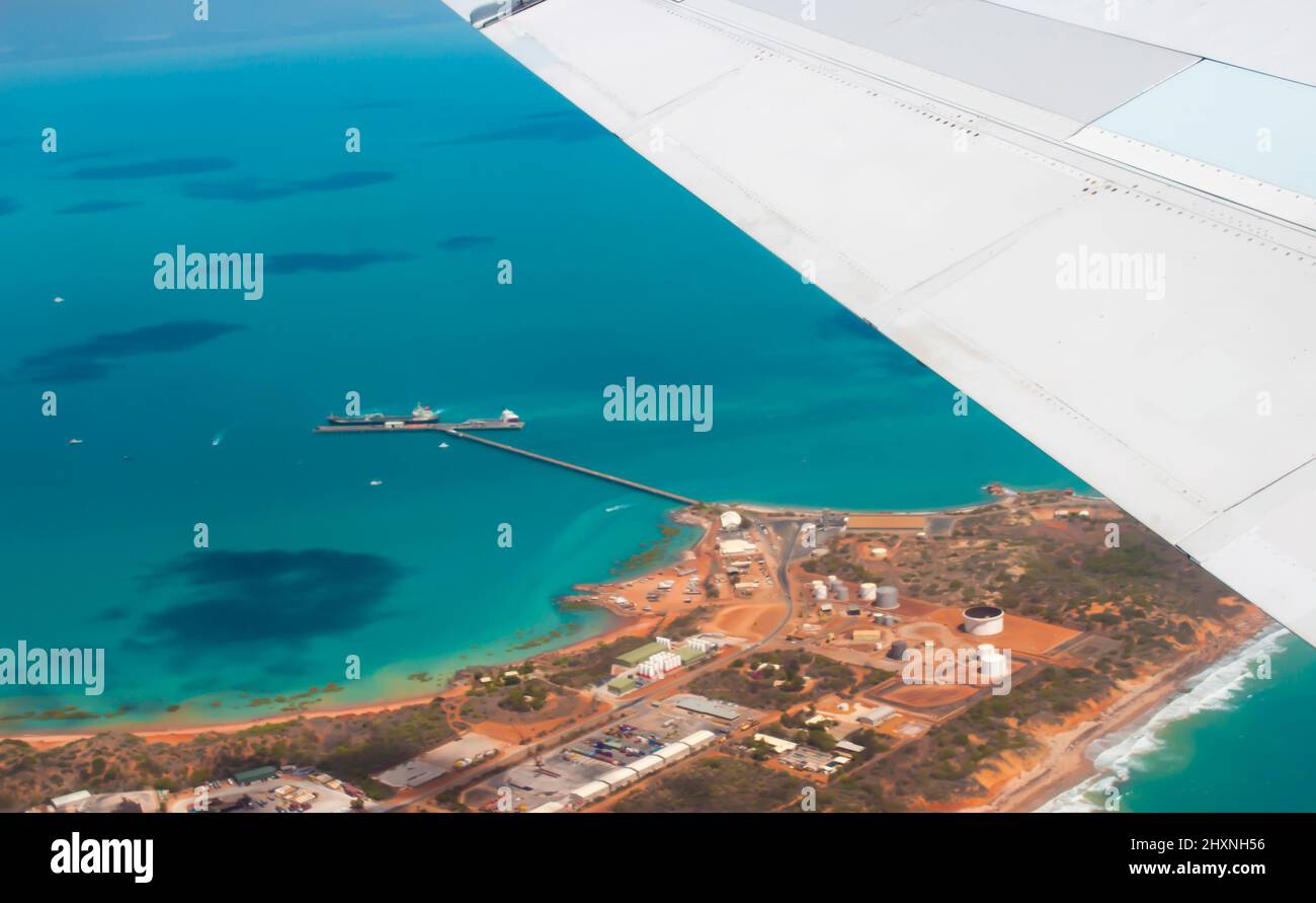 Aerial view of Broome, North Western Australia as the plane ascends for takeoff on sunny hot afternoon in the Summer Wet Season with the town below. Stock Photo
