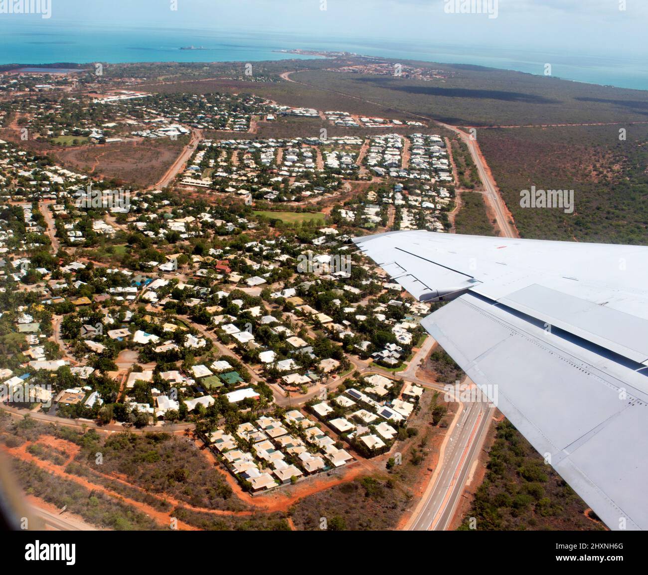 Aerial view of Broome, North Western Australia as the plane ascends for takeoff on sunny hot afternoon in the Summer Wet Season with the town below. Stock Photo