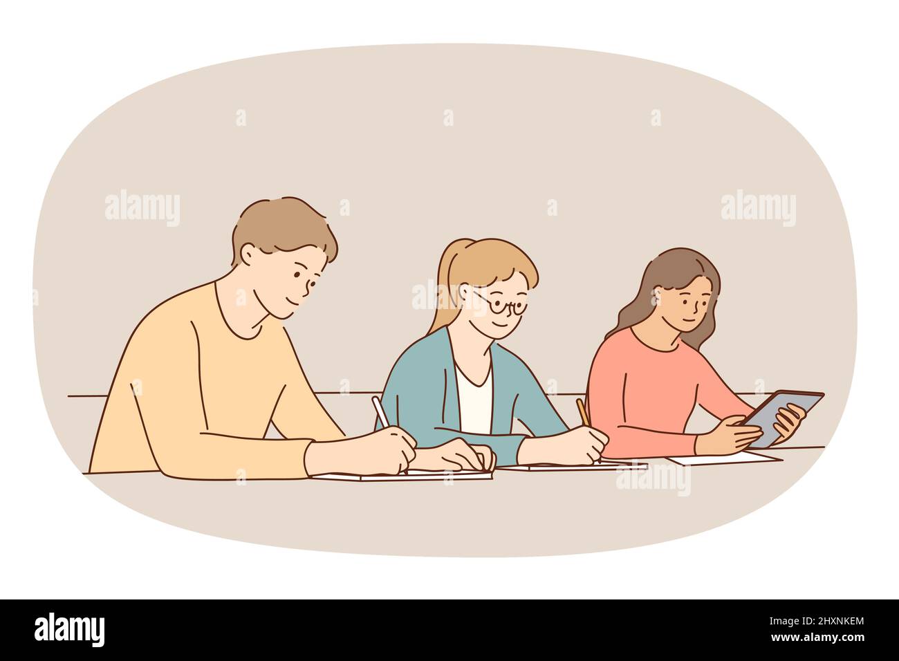 Young diverse people sit at desk study together in college or