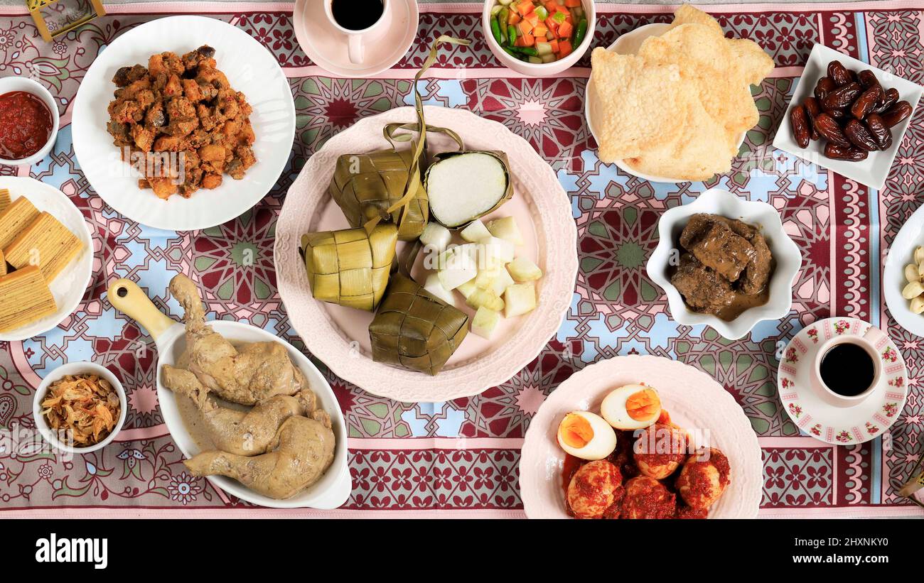 Ketupat Lebaran. Traditional Celebratory Dish of Rice Cake or Ketupat with Various Side Dishes, Popular Served During Eid Celebrations. Stock Photo