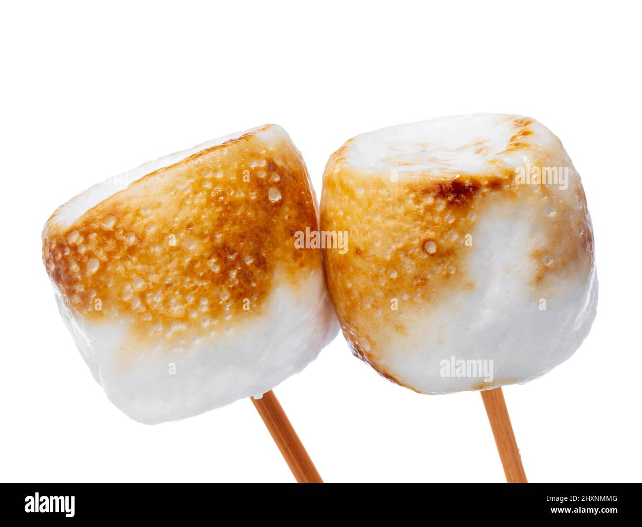 Grilled marshmallows on sticks isolated on white Stock Photo