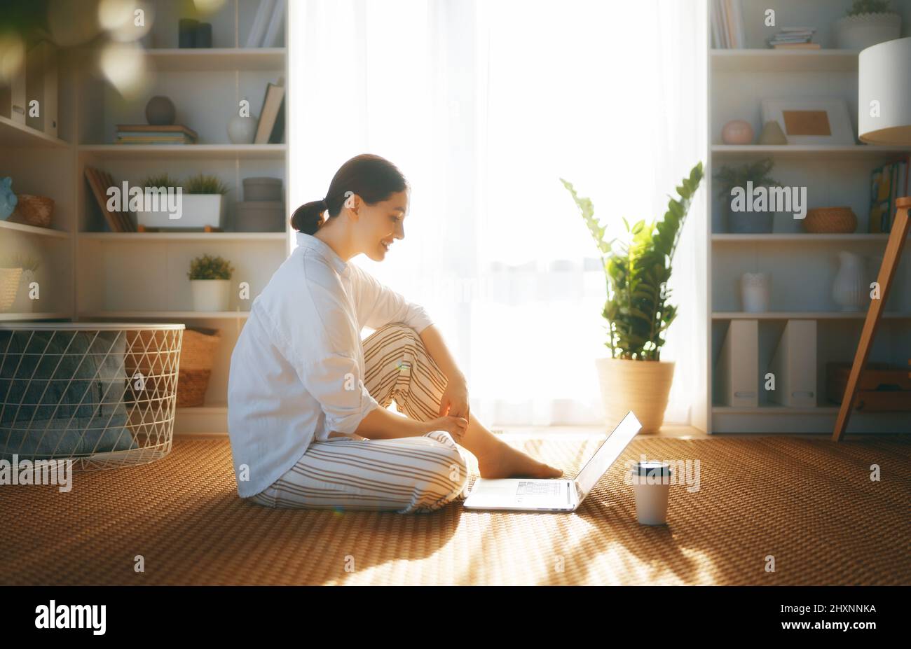 Happy casual beautiful woman using laptop at home Stock Photo - Alamy