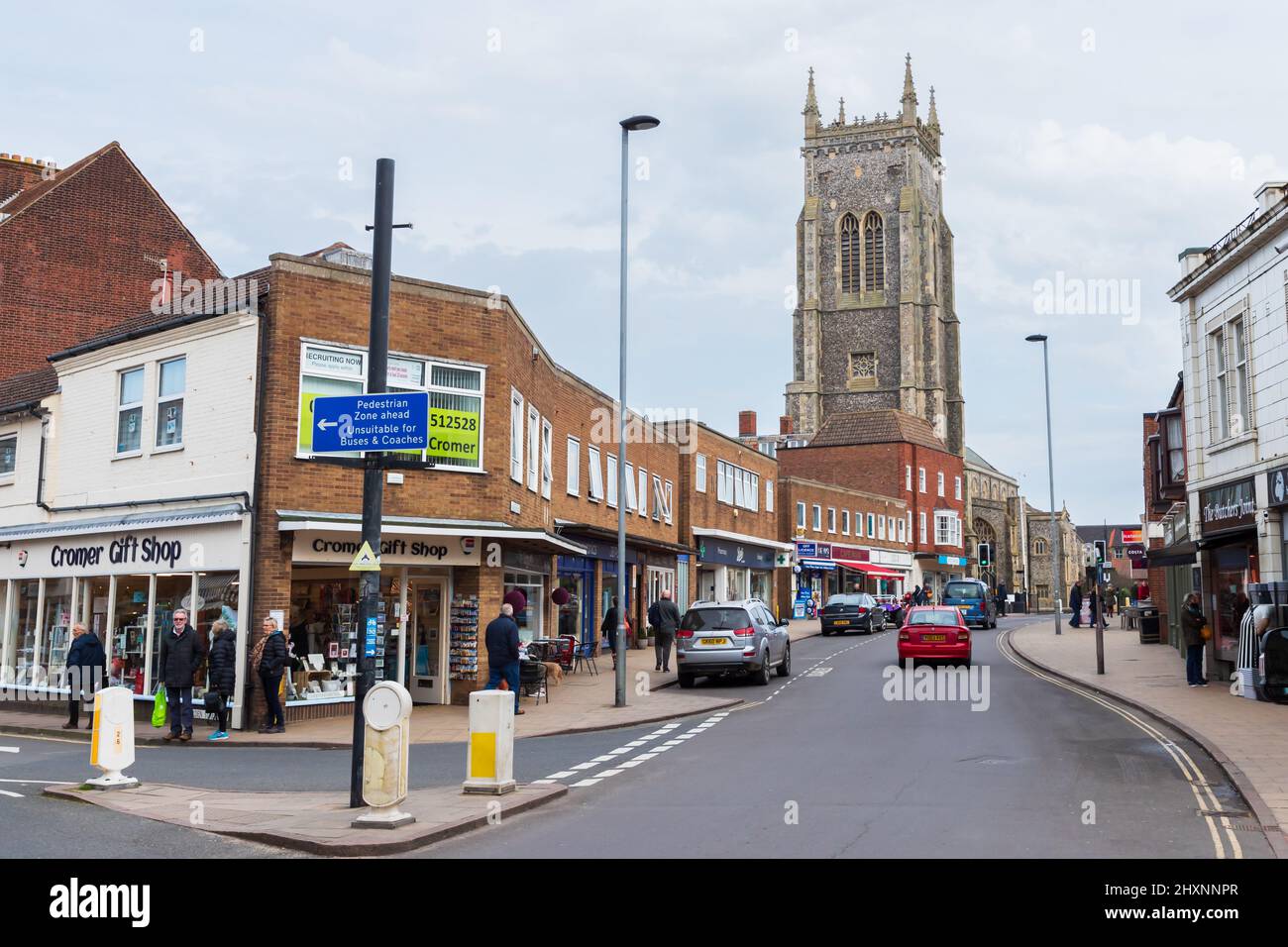 Cromer High Street along with the church towering over the buildings in North Norfolk in the UK Stock Photo