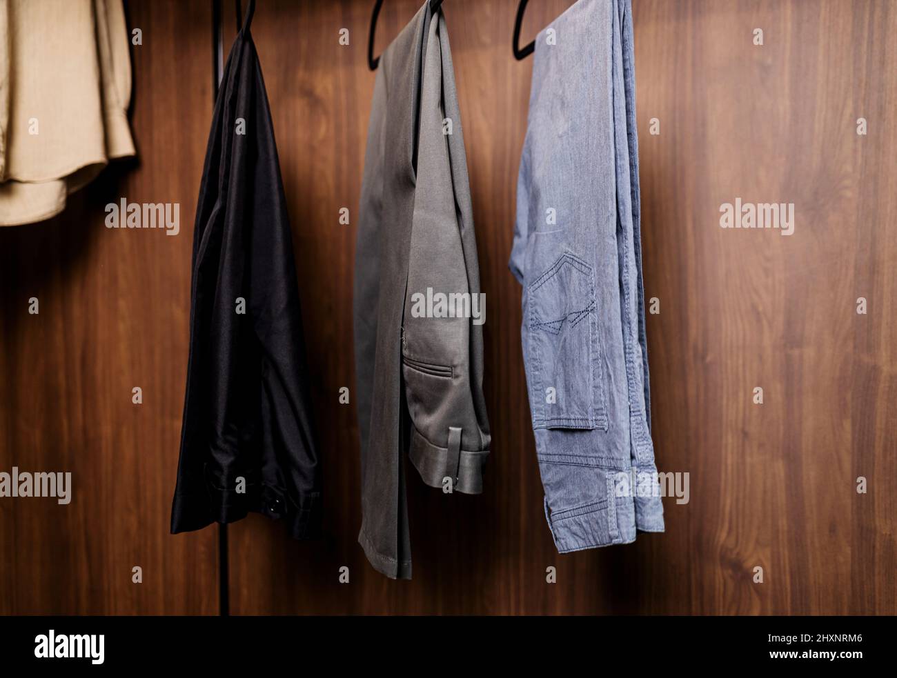 men's trousers and jeans on a hanger. fashion for men Stock Photo Alamy