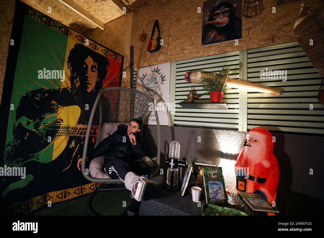 A customer smokes at a medical cannabis cafe in Tira, an Arab village in central Israel March 2, 2022. Picture taken on March 2, 2022. REUTERS/Ammar Awad Stock Photo