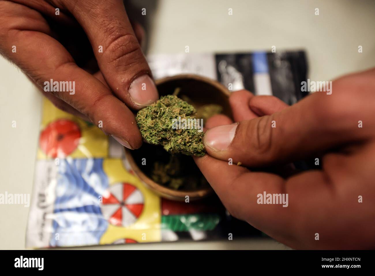 A worker prepares joints for customers at a medical cannabis cafe in Tira, an Arab village in central Israel March 2, 2022. Picture taken on March 2, 2022. REUTERS/Ammar Awad Stock Photo