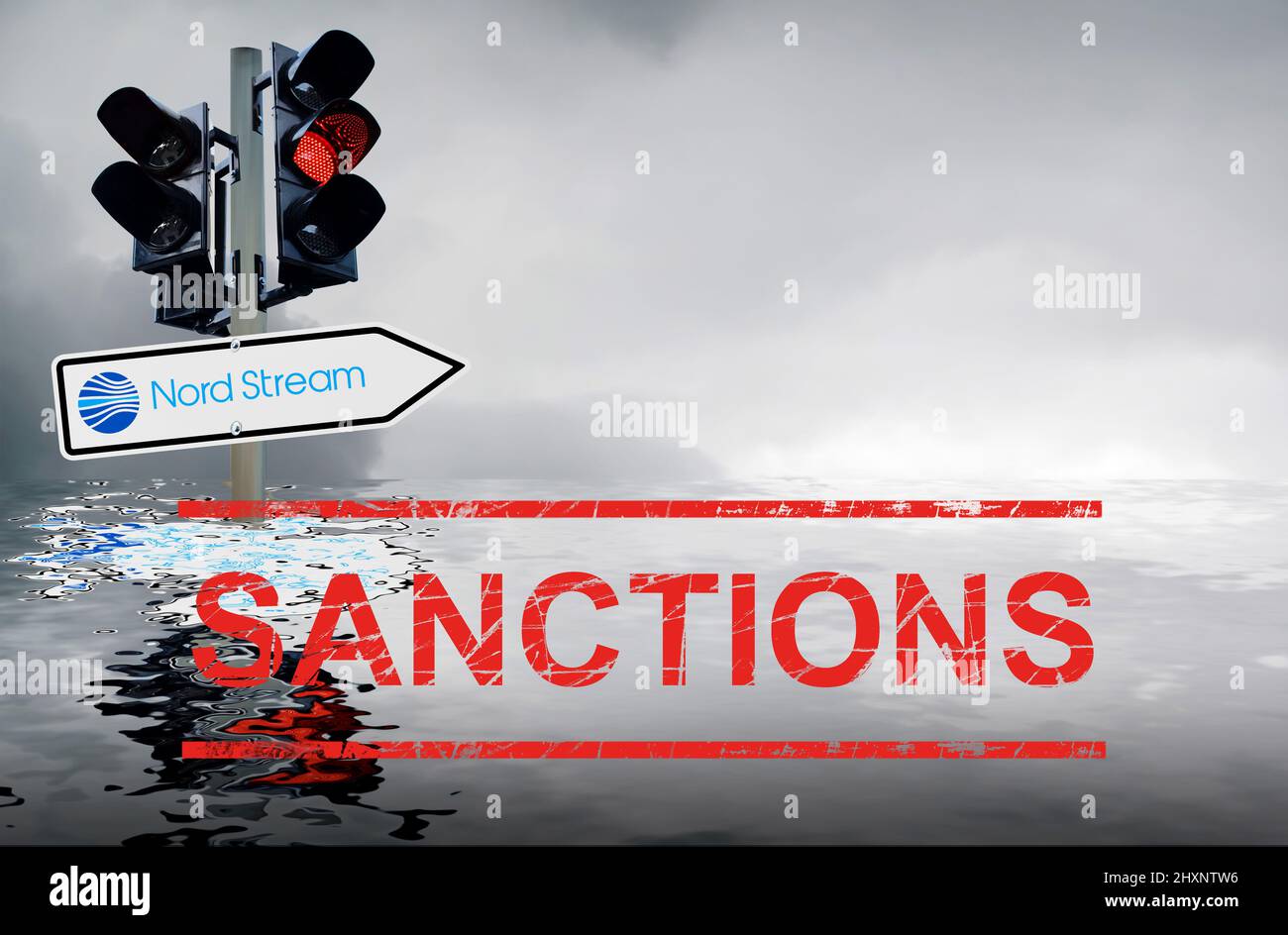Symbolic image Nord Stream sanctions: Traffic light with traffic sign and grey sky reflected in the sea Stock Photo