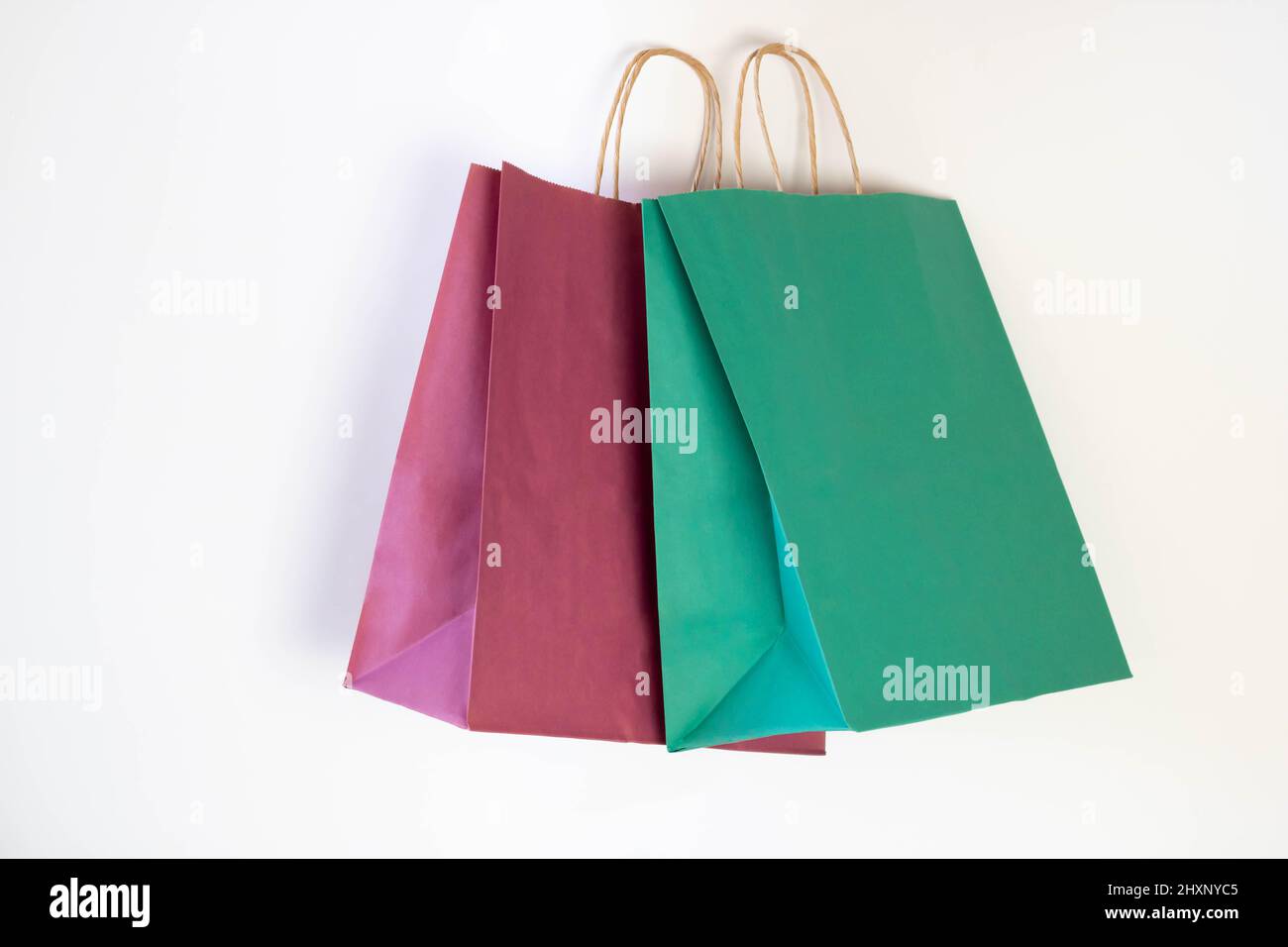 Ecology concept Colored paper shopping Bags Isolated on a white background. Stock Photo