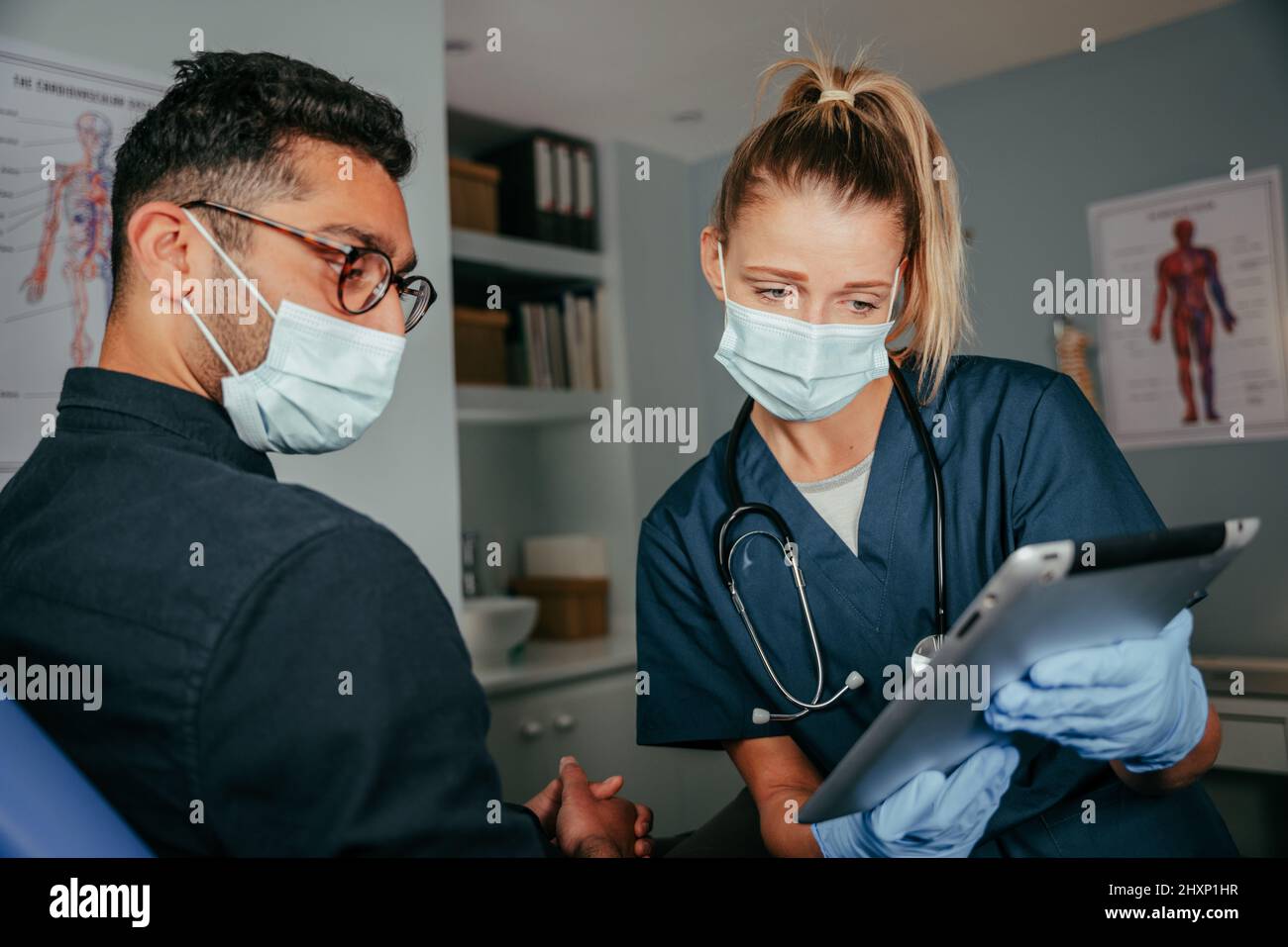 Caucasian nurse explaining information on digital tablet  Stock Photo