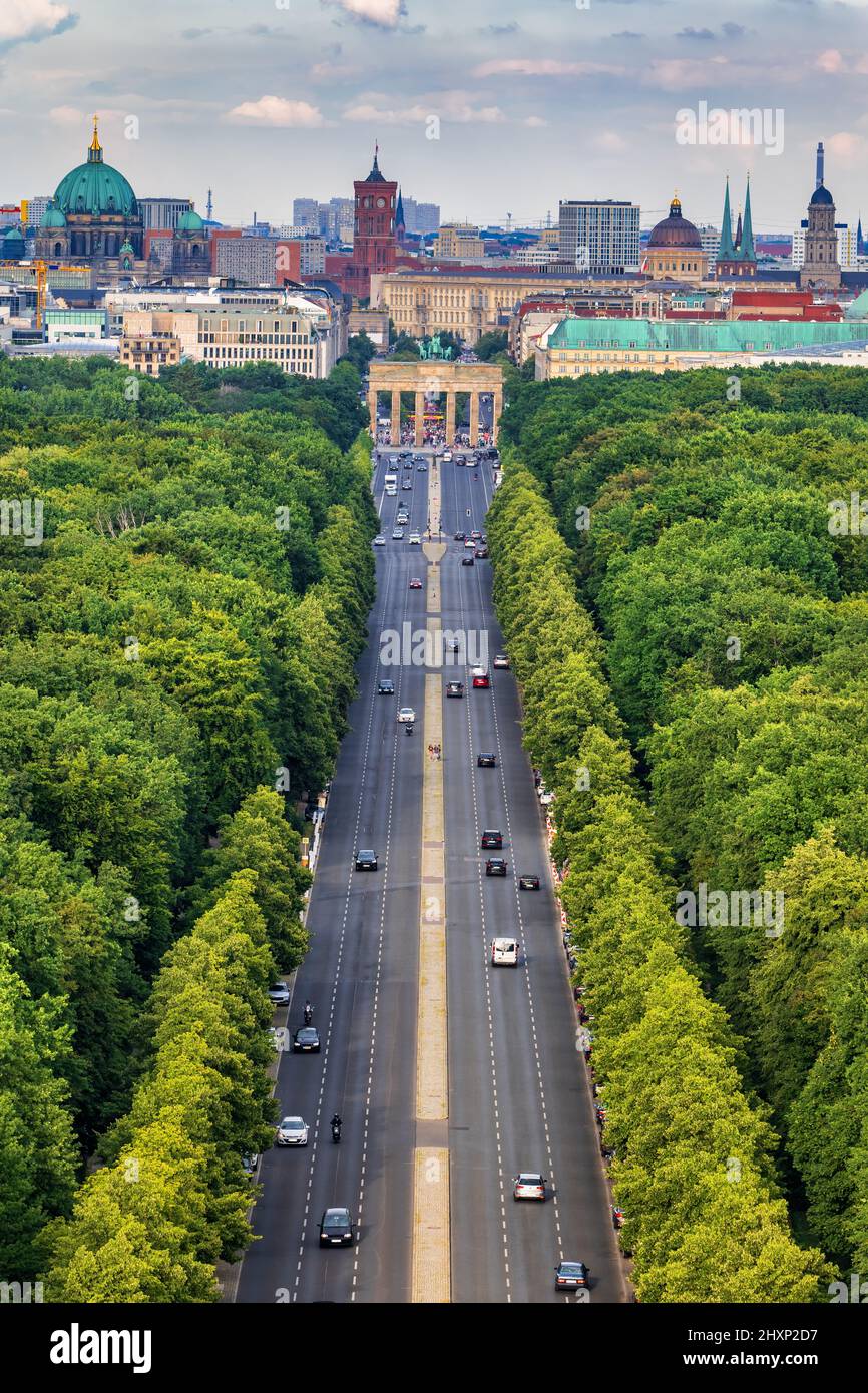 Berlin city skyline in Germany, aerial view above street through Tiergarten park towards the Brandenburg Gate. Stock Photo