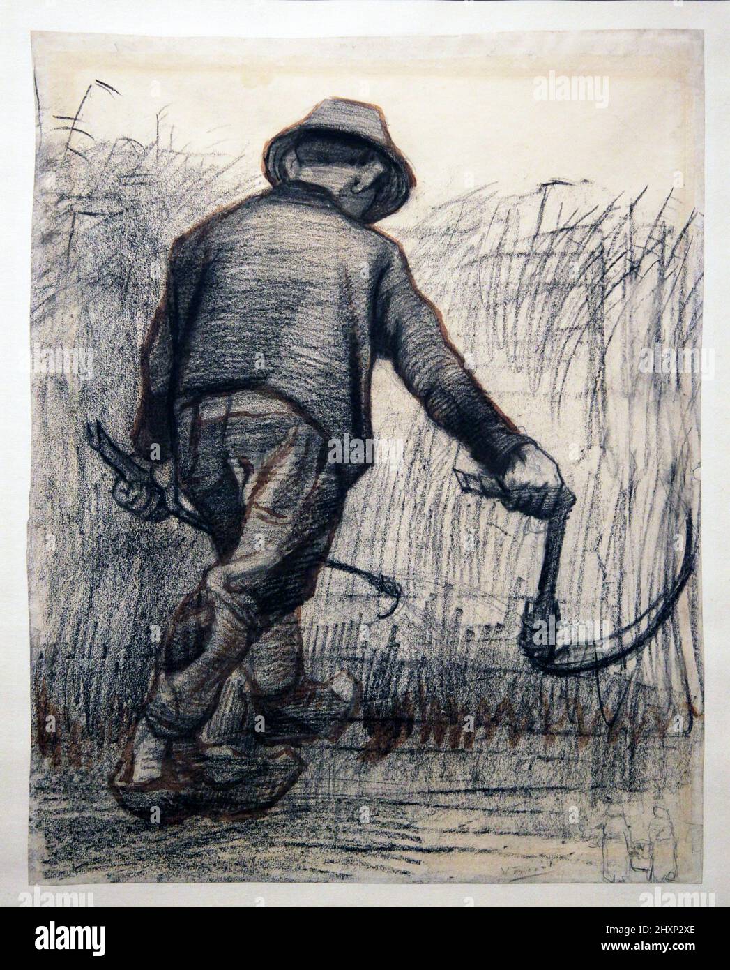 Wheat Reaper with Hat,seen from behind (1885) by Vincent van Gogh (1853-1890).pencil,black chalk and brown wash on paper. Stock Photo