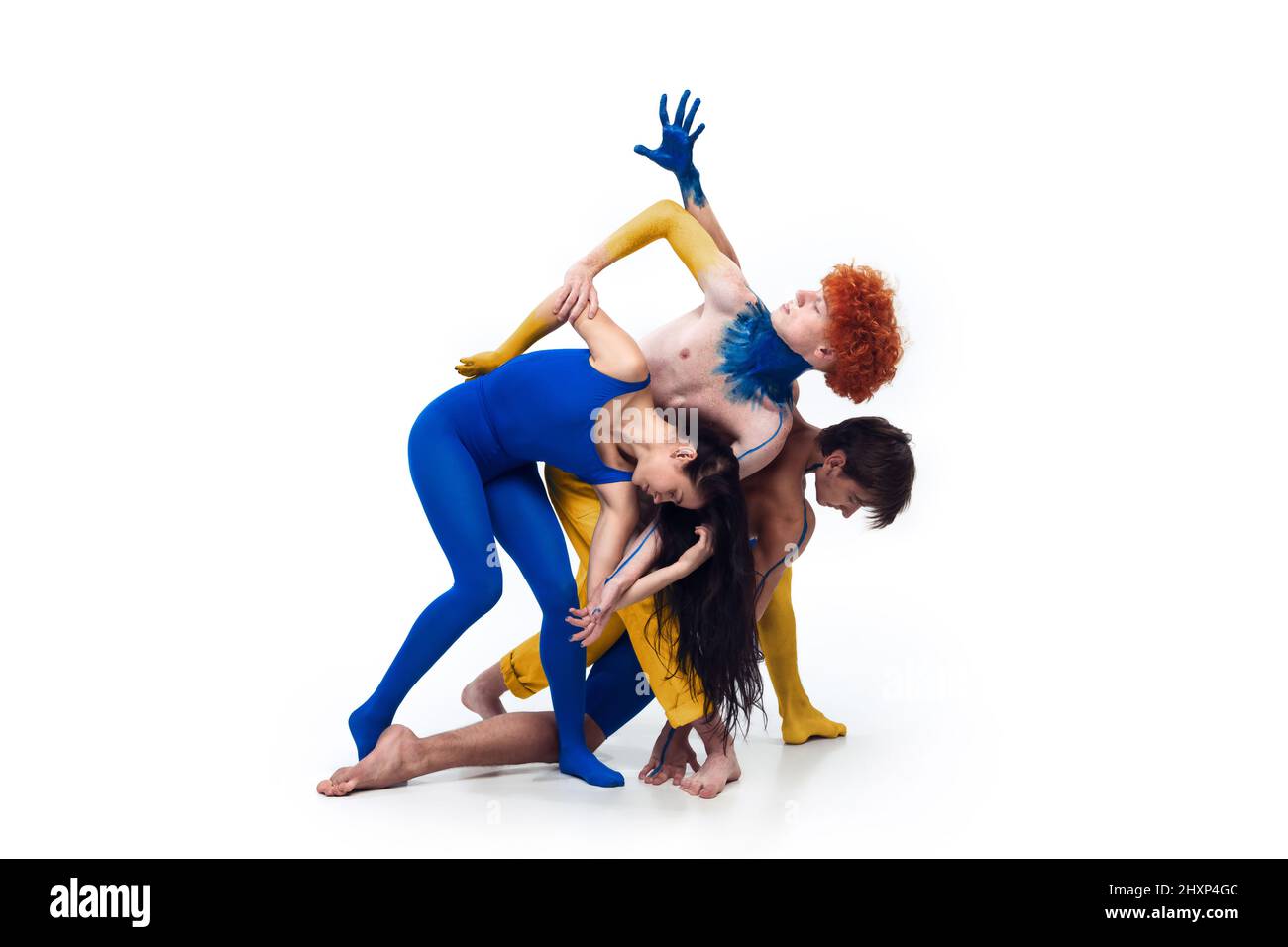 The group of modern ballet dancers. Contemporary art ballet. Young men an women painted in blue and yellow colors of Ukrainian flag Stock Photo