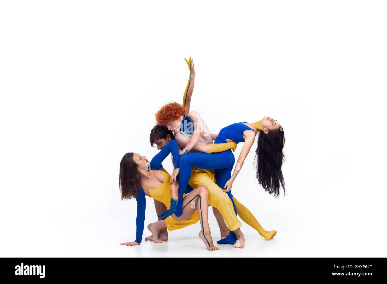 The group of modern ballet dancers. Contemporary art ballet. Young men an women painted in blue and yellow colors of Ukrainian flag Stock Photo