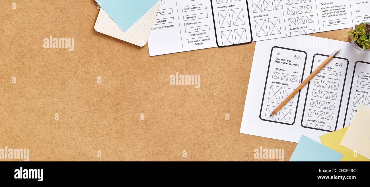 Web product design concept web banner with copy space. Top view image of a UX designer workspace with mobile app wireframe sketches. Stock Photo