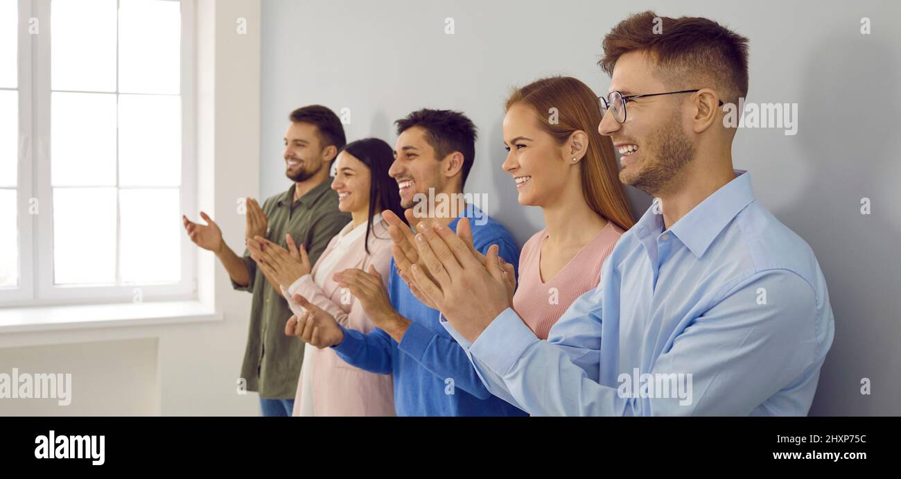 Happy businesspeople clap hands show acknowledgement Stock Photo