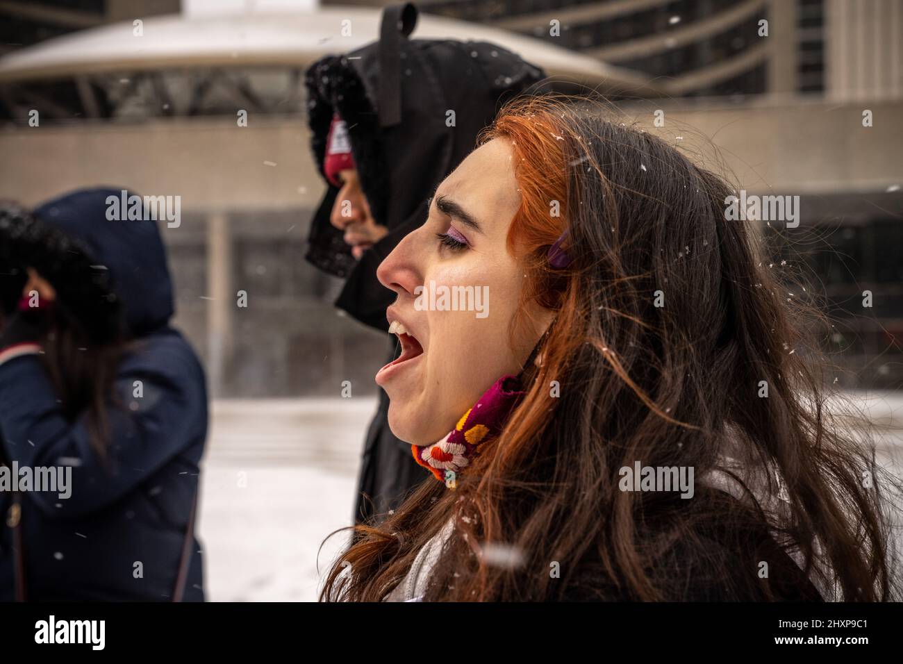 Toronto, Canada. 13th Mar, 2022. A protester chants slogans during the ...