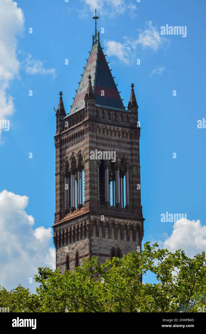 The Old South Church Tower in Boston with some trees in foreground under a slightly cloudy blue sky Stock Photo