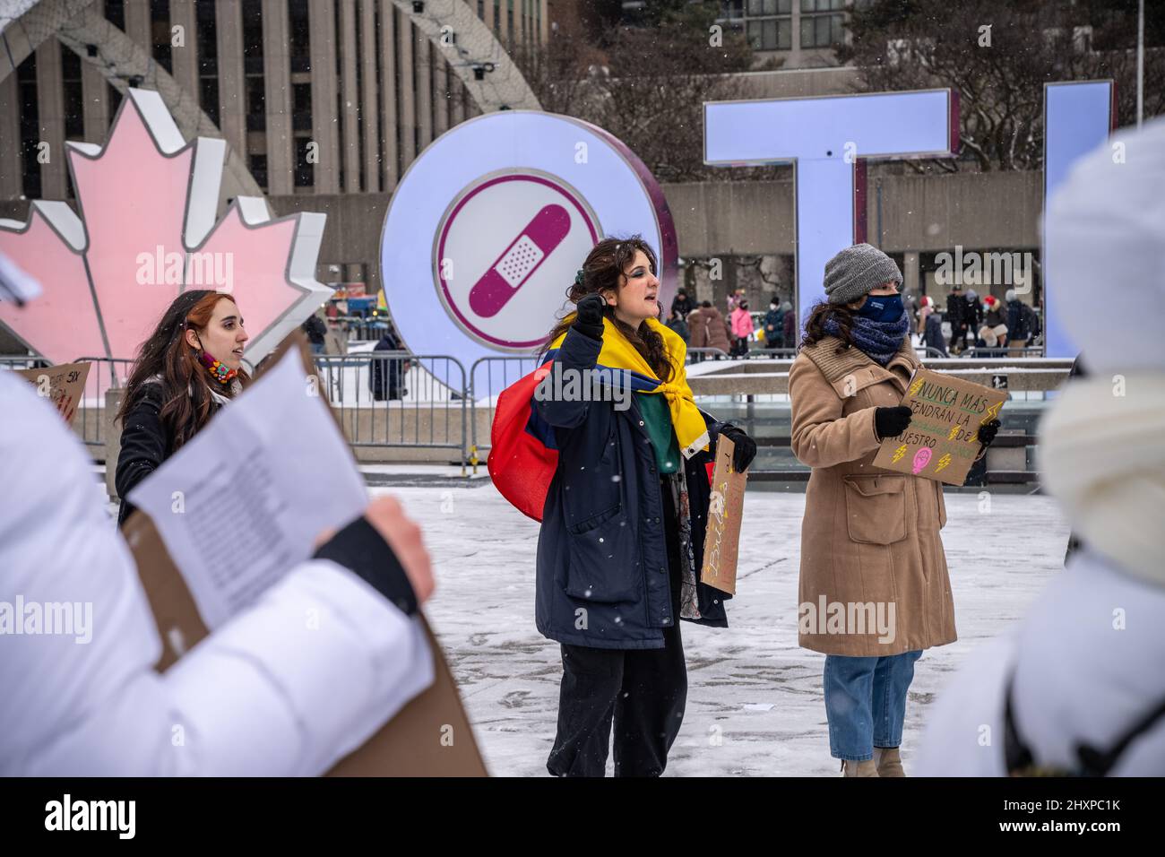 A protester holds a placard while listening to speeches during the ...
