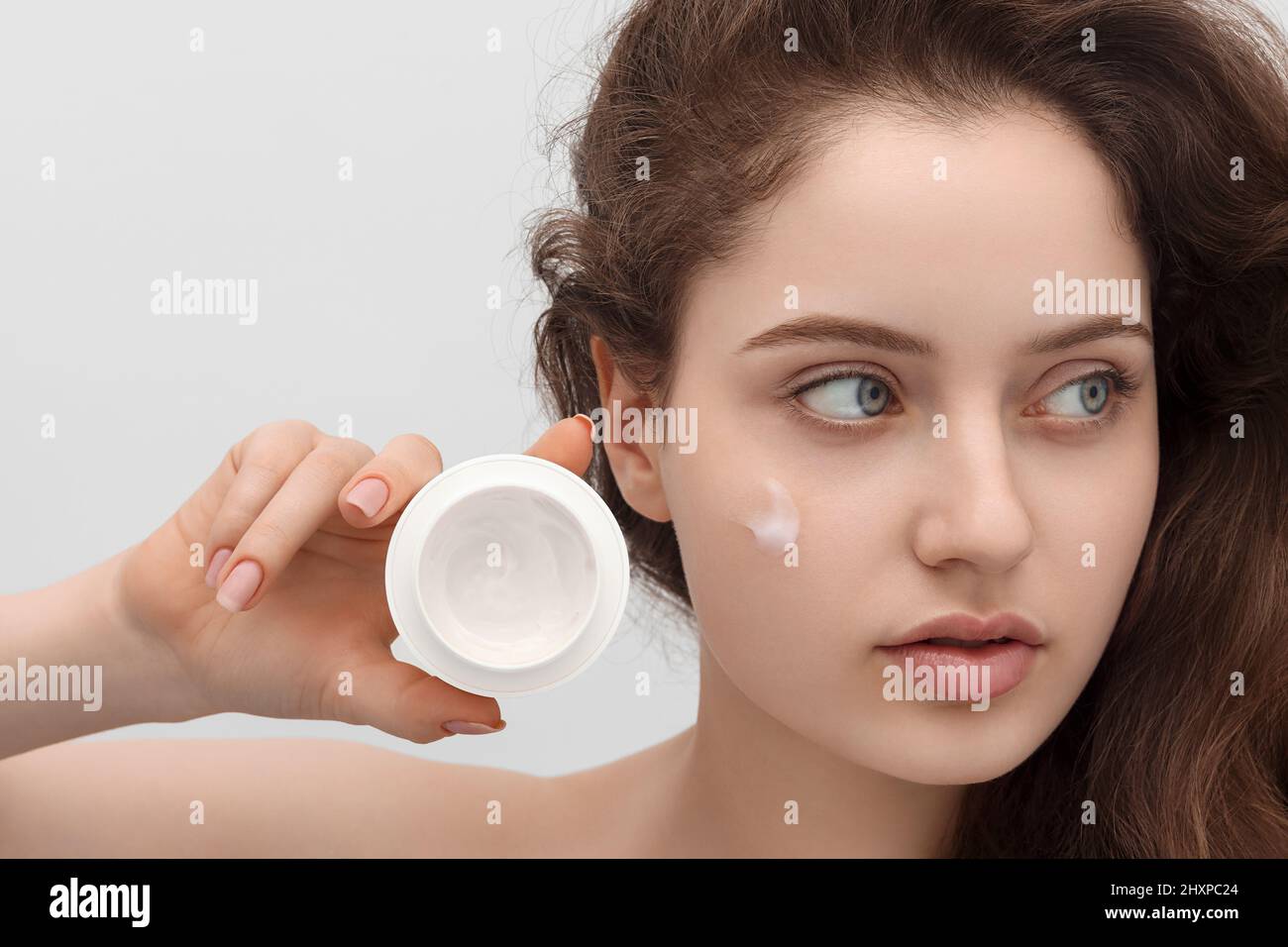 Young girl with face cream, close up Stock Photo Alamy