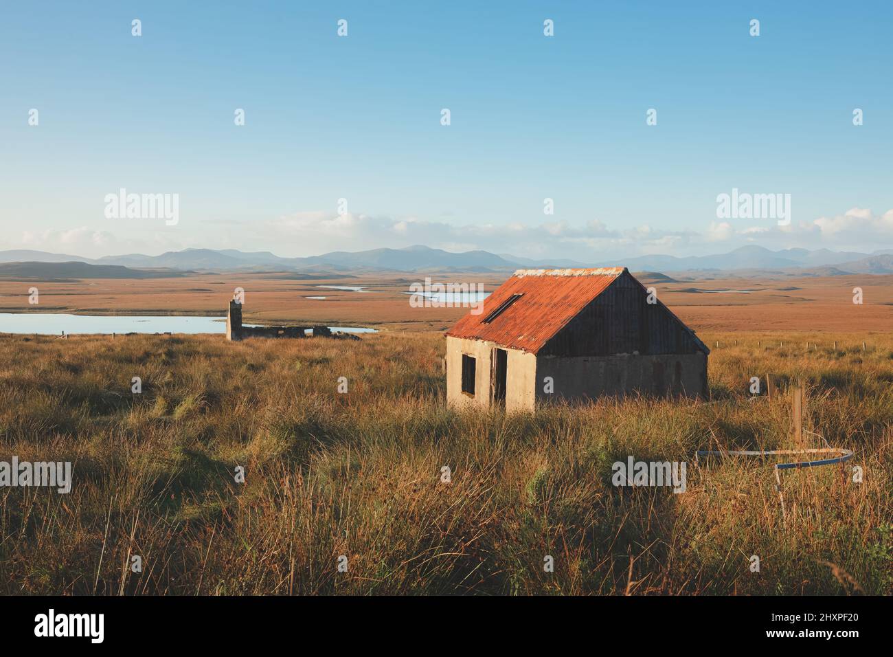 Old stone ruins of an abandoned bothy and cottage in the moorland mountain landscape on the Isle of Lewis and Harris in the Outer Hebrides, Scotland. Stock Photo