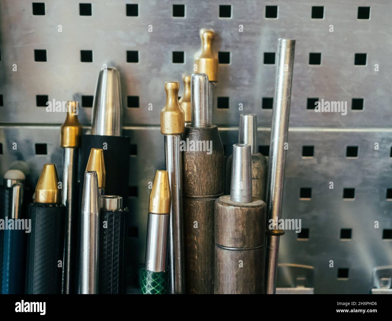 glass blowing tools, glass blowing pipes on metal wall, horizontal