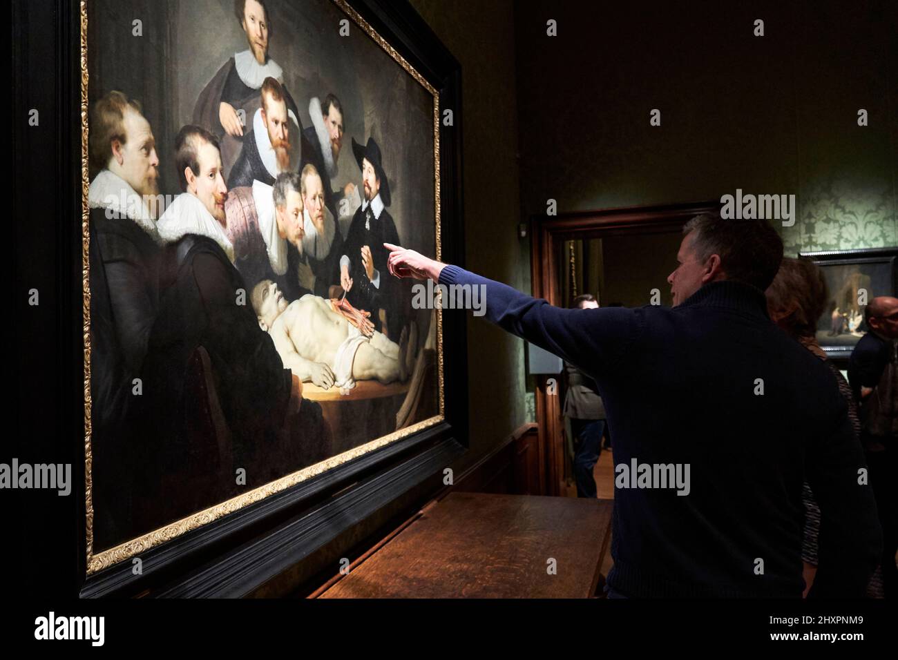 Visitors to the Mauritshuis Museum looking at Rembrandt's painting 'Anatomy Lesson'. Stock Photo