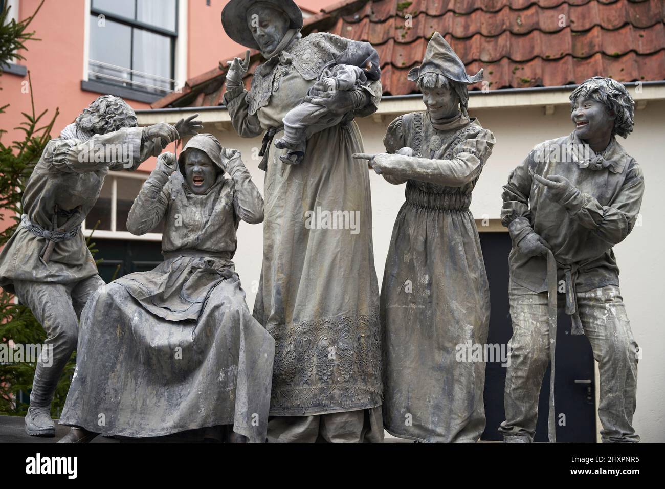 A group of living statues recreate typical scenes of the epoch Stock Photo