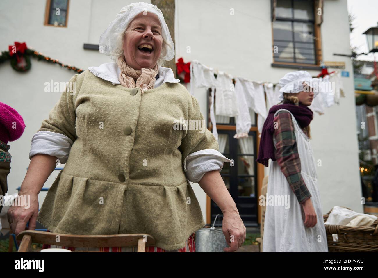 A woman participates in the event together with a group of girls disguised as laundresses Stock Photo