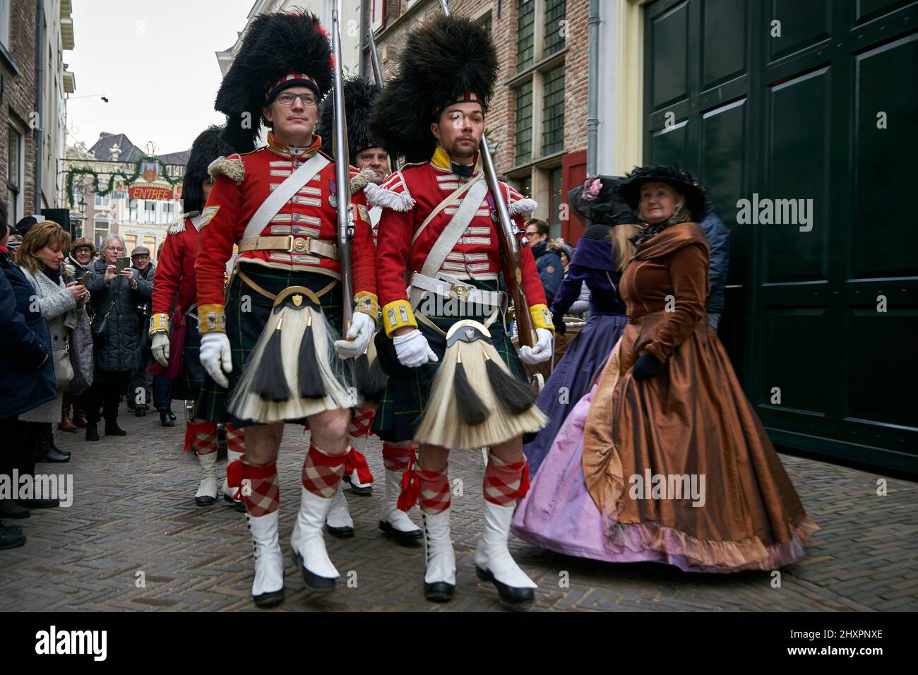 A group of participants parade through the streets of Deventer dressed as British soldiers Stock Photo