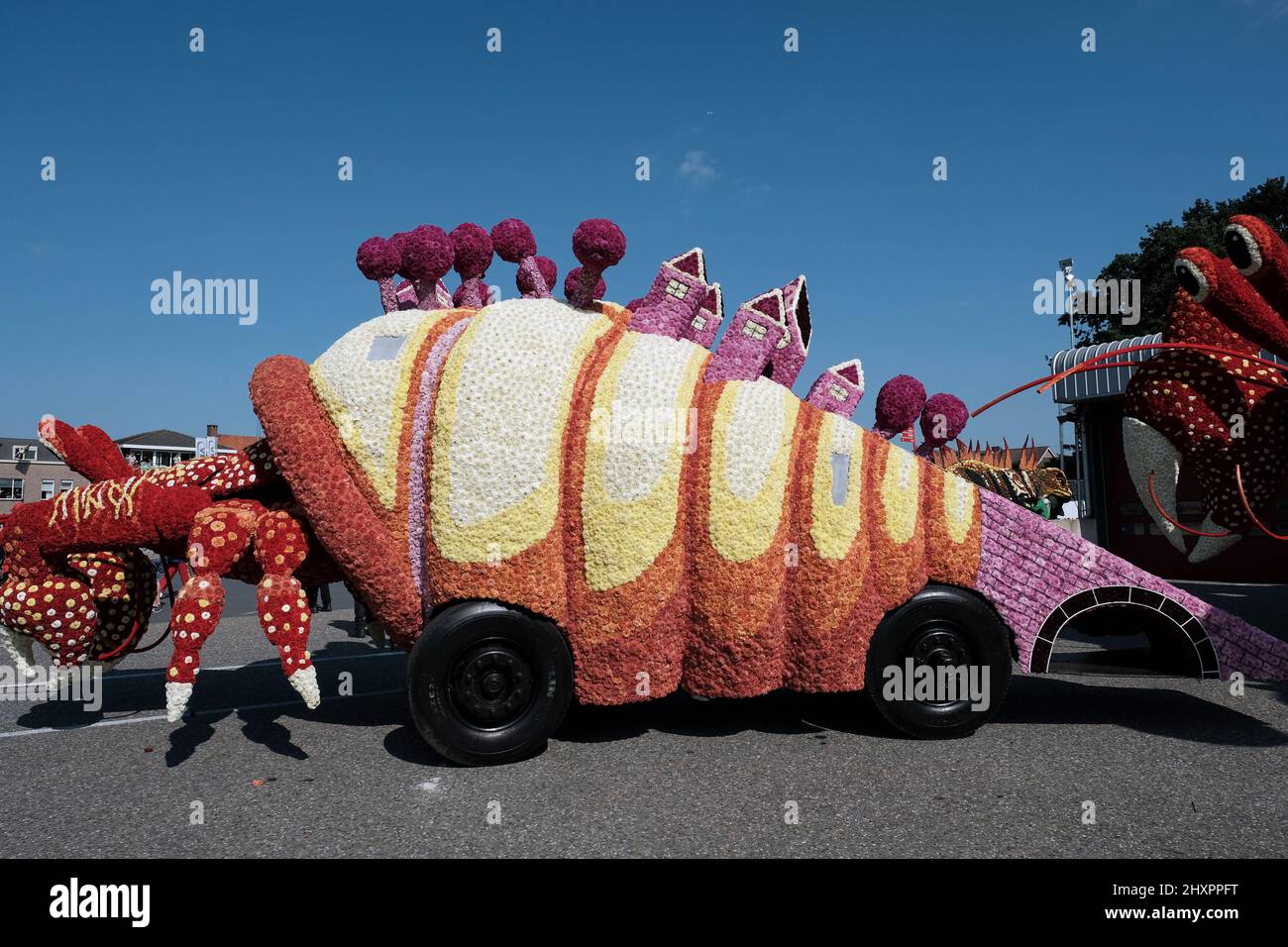 A mollusc-shaped float belonging to the 'Urbanisation' float waits for the parade to begin. Stock Photo