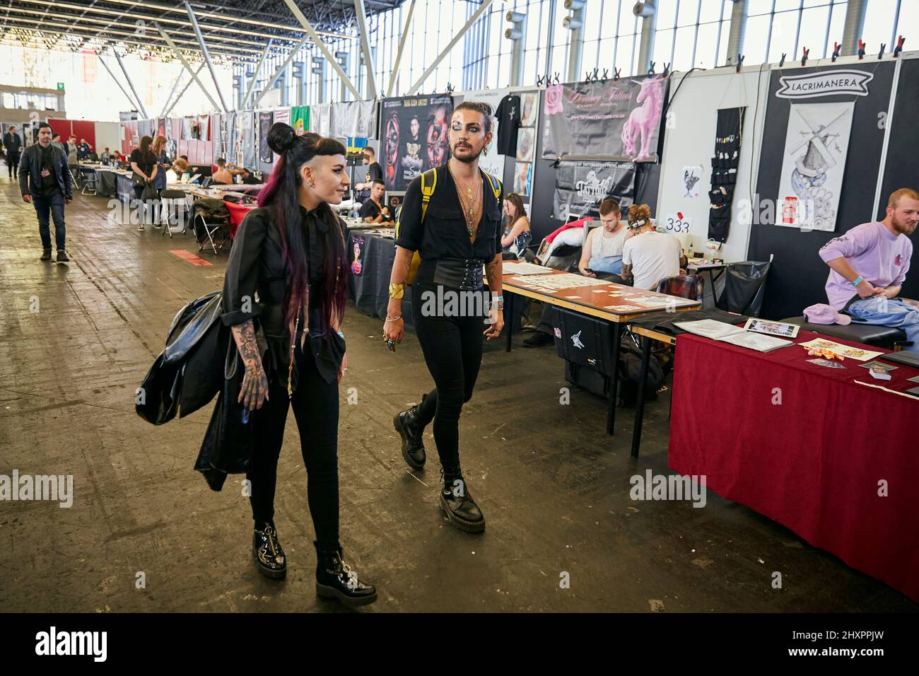 Attendees at the international tattoo convention walk among the stands where tattoo artists exhibit their designs in Amsterdam Stock Photo