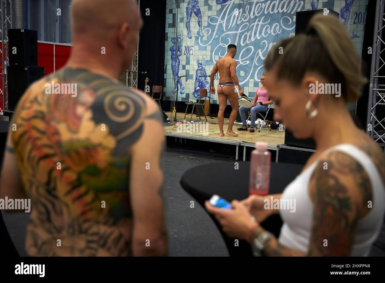 Participants of the tattoo convention attend a striptease show Stock Photo