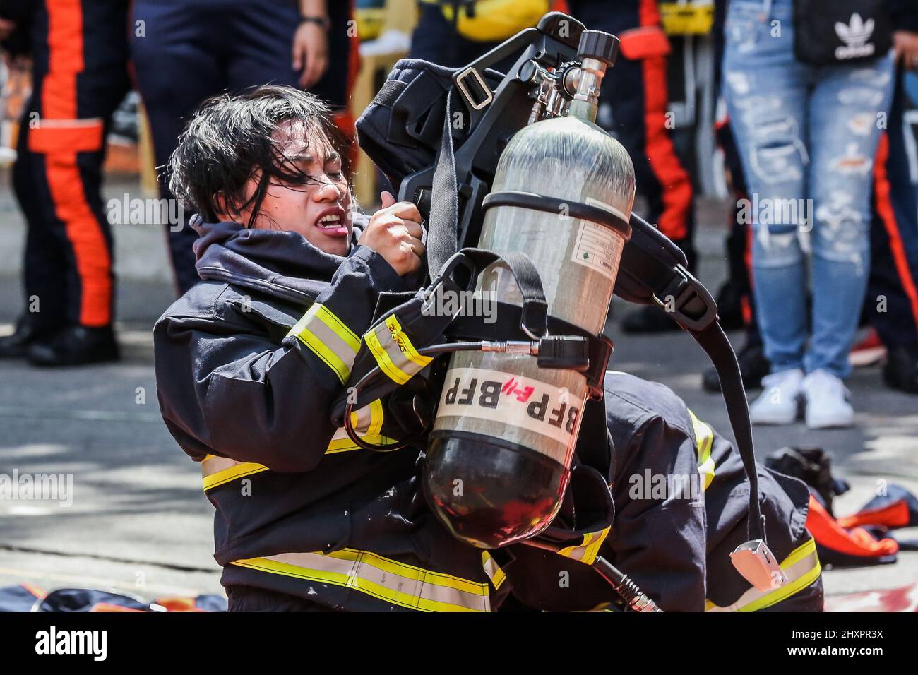 Quezon City. 14th Mar, 2022. A female firefighter participates in the