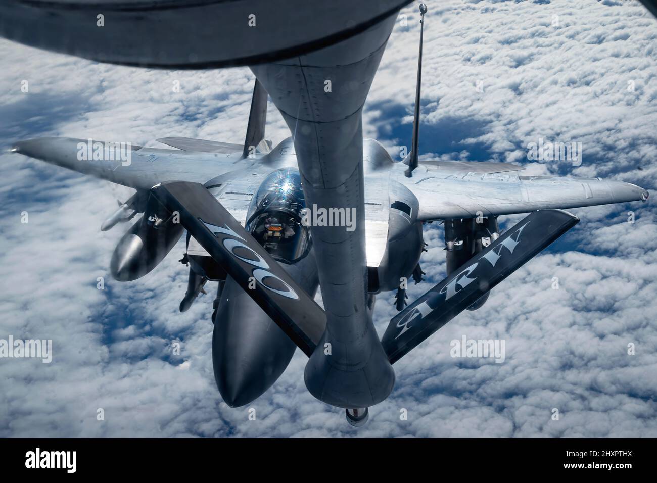 A U.S. Air Force Boeing KC-135 Stratotanker provides fuel to an F15E Strike Eagle over Eastern Europe, Feb. 26, 2022. The 100th Aerial Refueling Wing assigned to Royal Air Force Mildenhall is currently operating missions out of Ramstein Air Base, Germany, providing 24-hour support to NATO allies and partners. (U.S. Air Force Airman 1st Class Edgar Grimaldo) Stock Photo