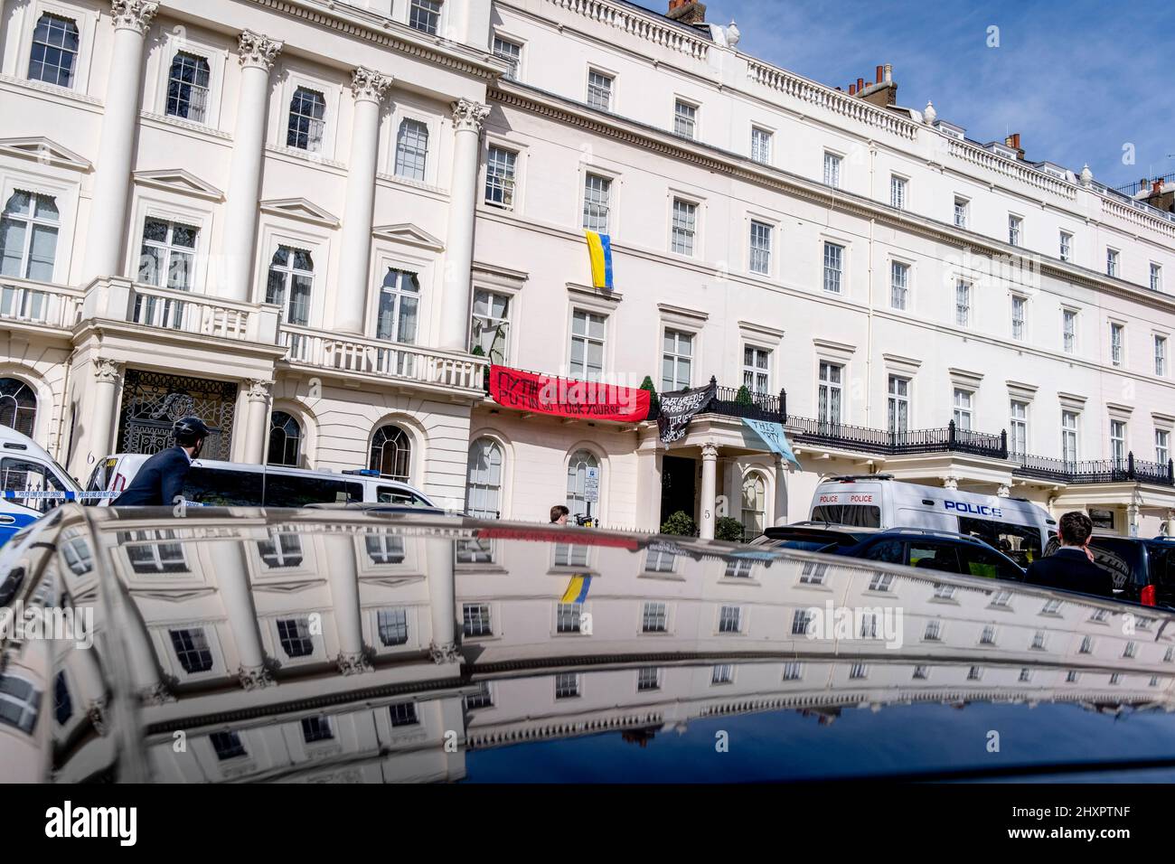 Protesters occupy the property of Russian Oligarch and Putin ally, Oleg Deripaska at 5 Belgrave Square in Knightsbridge, on 14th March 2022, in London, England. The Squatters have hanged the Ukrainian flag from an upper window and show banners saying, 'This property has been liberated' and an anti-Putin slogan. Stock Photo