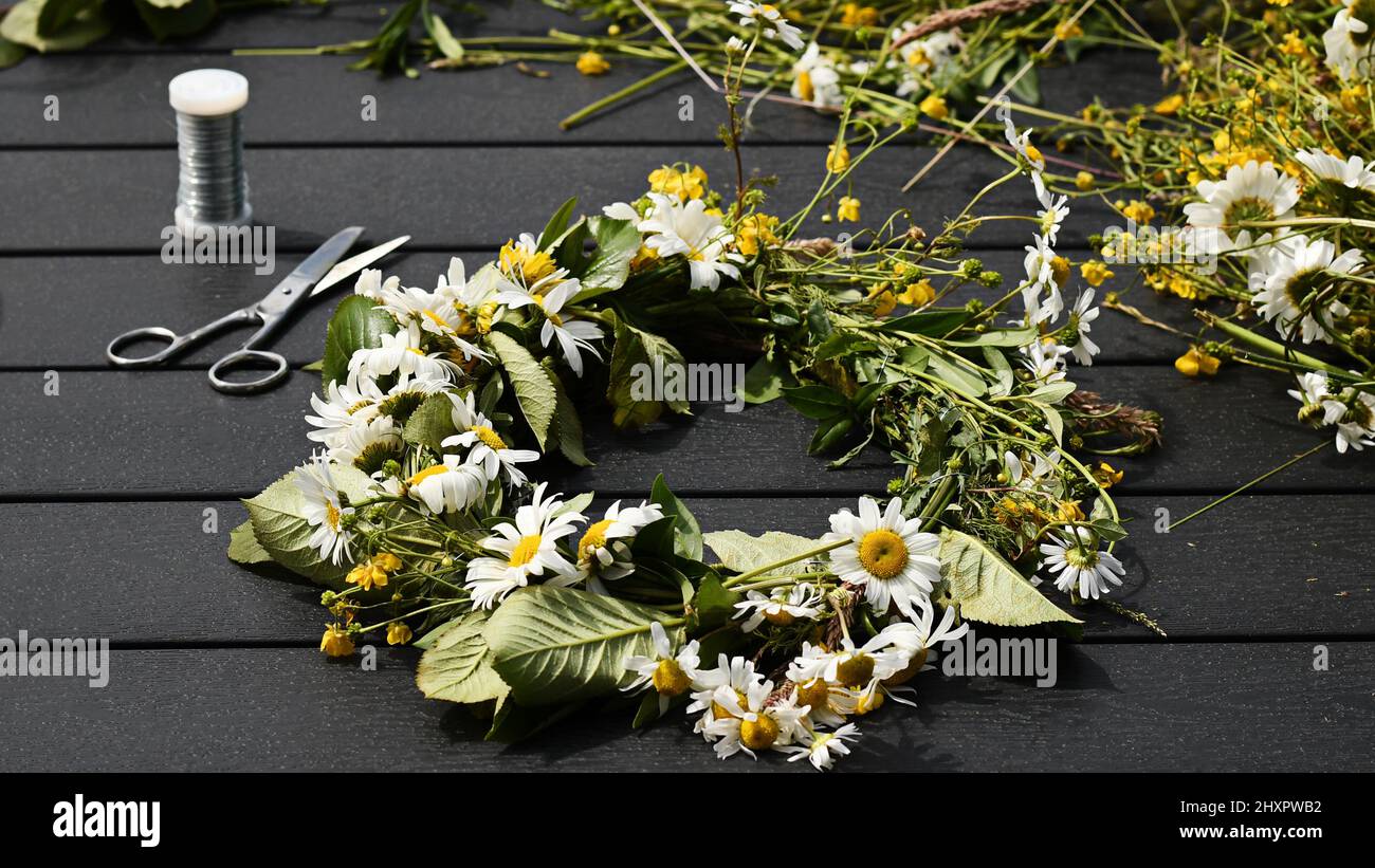 Traditional Swedish Midsummer flower crown, made with wild summer and by using wire and scissor. Beautiful hair accessory. Photo taken in Sweden. Stock Photo