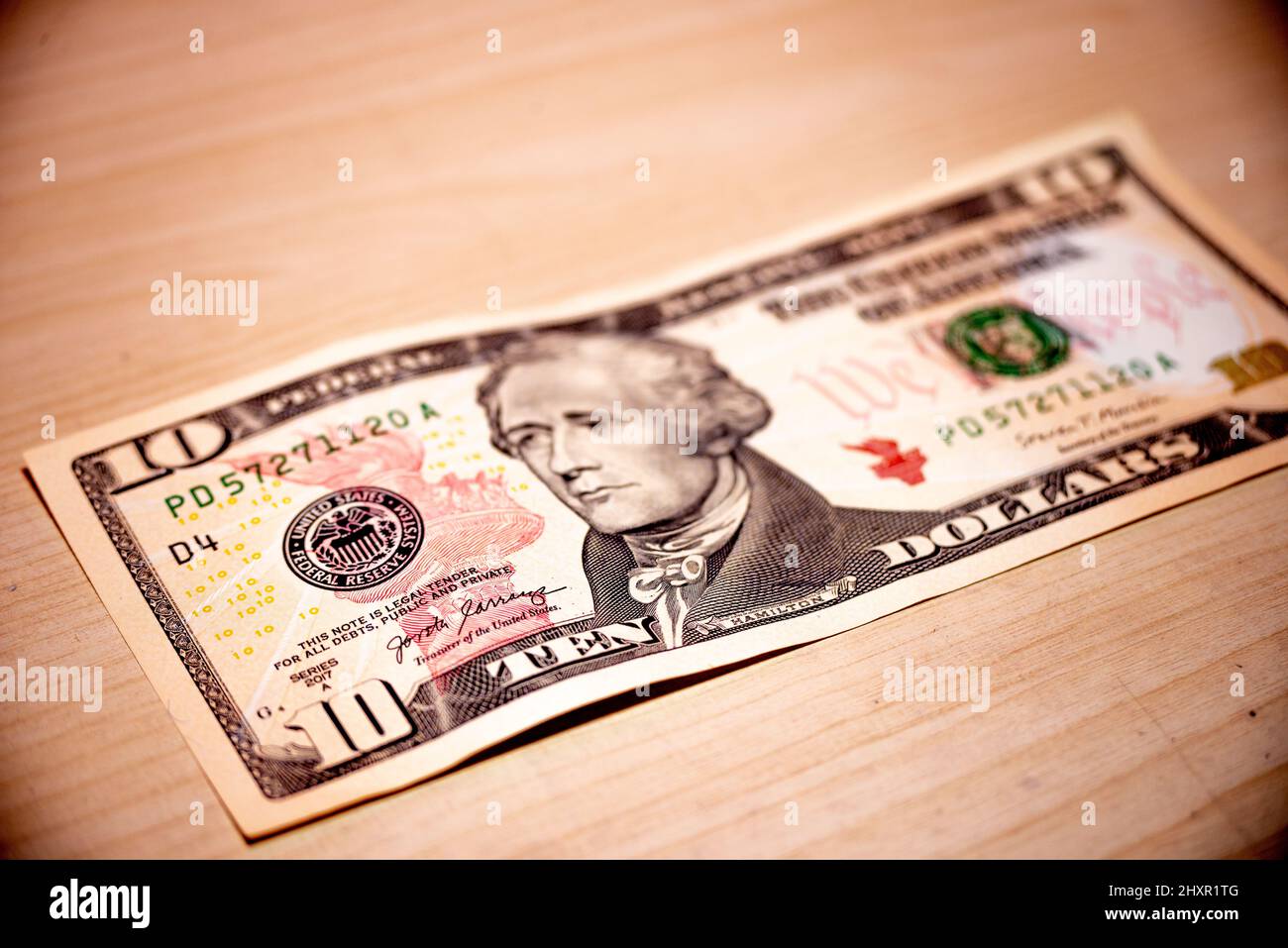 Ten US dollar bill in a wood table. Us banknote Stock Photo - Alamy