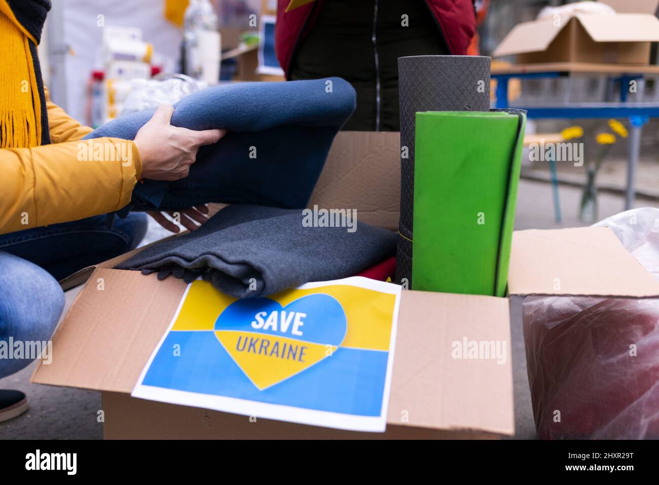 Volunteers distributing blankets and other donations to refugees on the