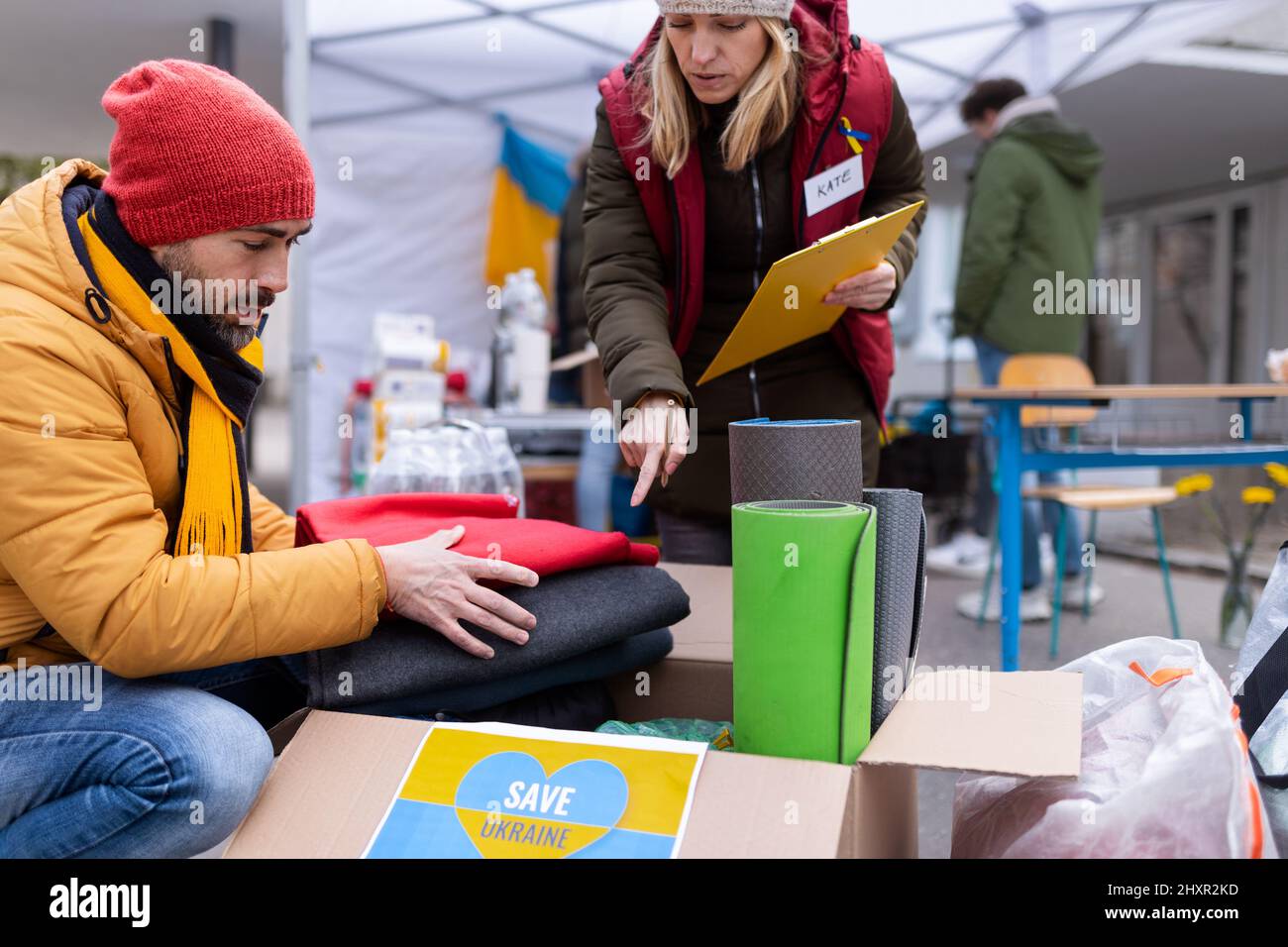 Volunteers distributing blankets and other donations to refugees on the