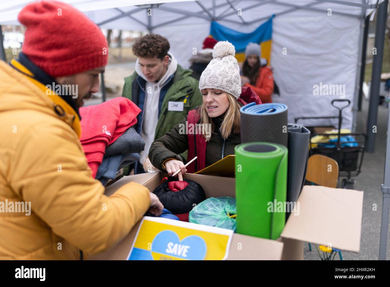 Volunteers distributing food and drink to refugees on the Ukrainian border, humanitarian aid