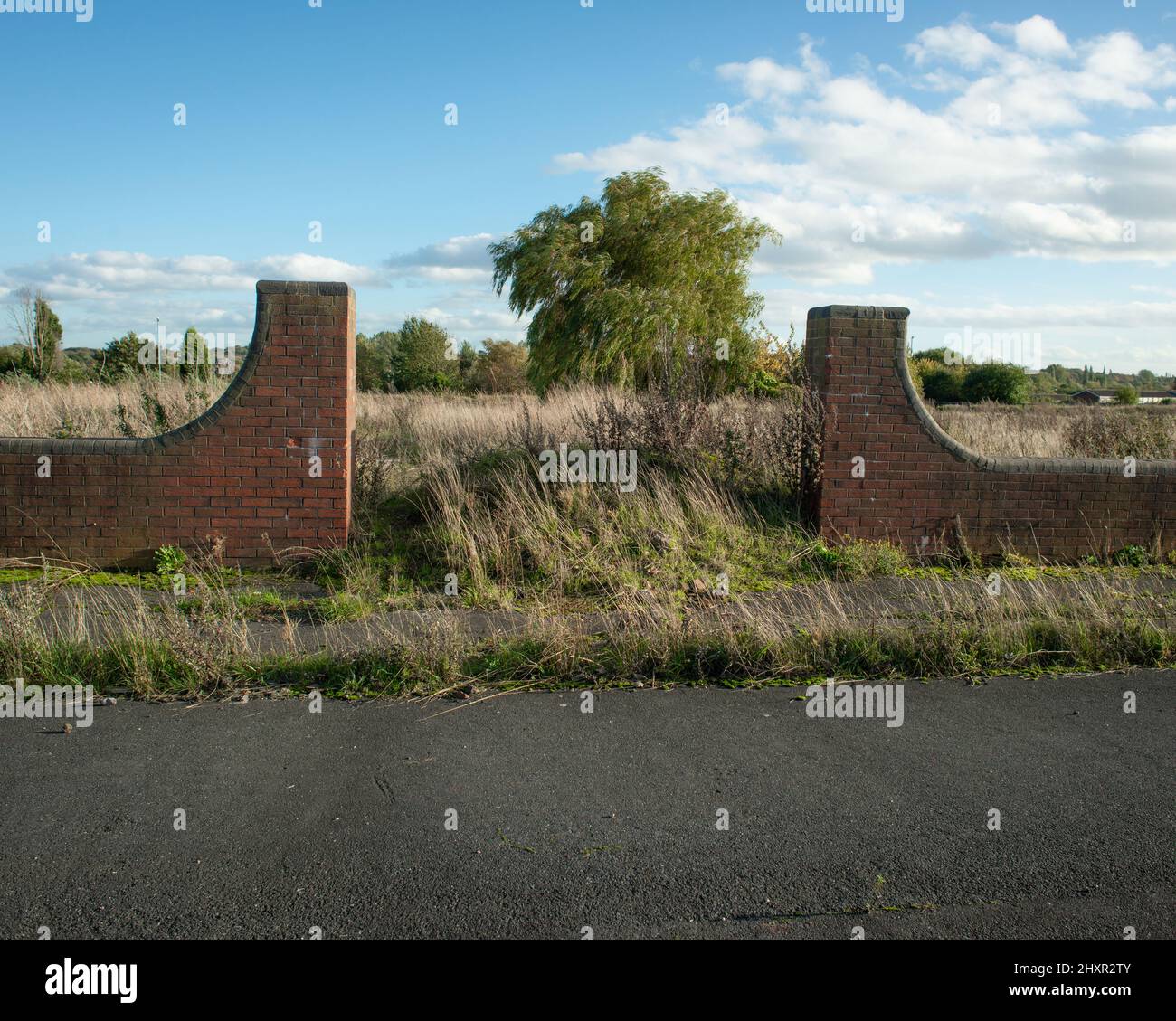 Abandoned road and brick structure on brownfield site Stock Photo Alamy