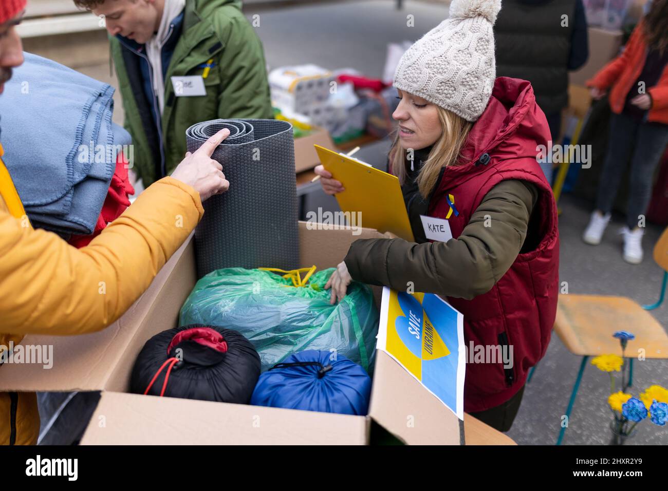 Volunteers distributing blankets and other donations to refugees on the