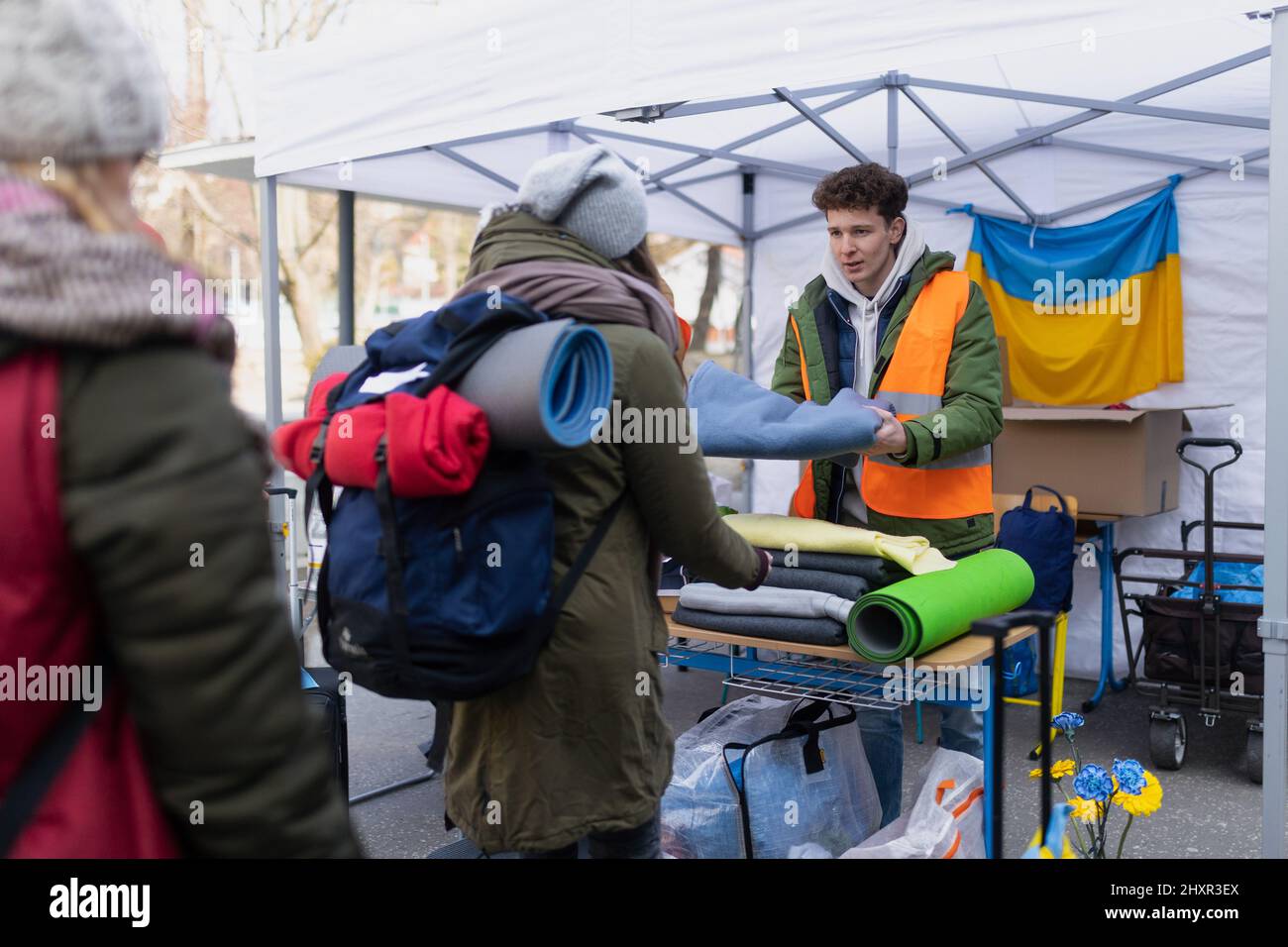 Volunteers distributing blankets and other donations to refugees on the