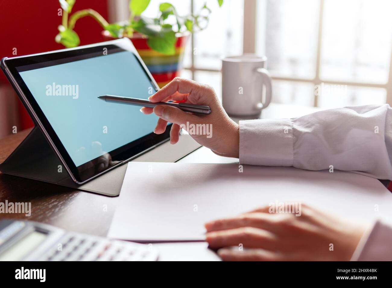 Woman using digital tablet with digital pencil, businesswoman or student. Working from home concept Stock Photo