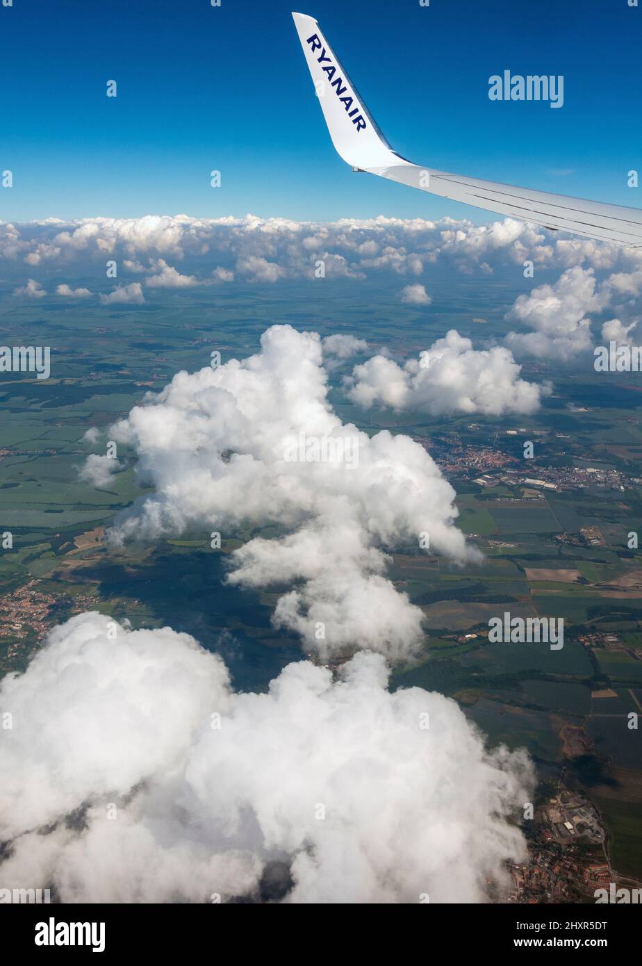 Ryanair aeroplane flying above the clouds showing Ryanair wing tip and logo Stock Photo