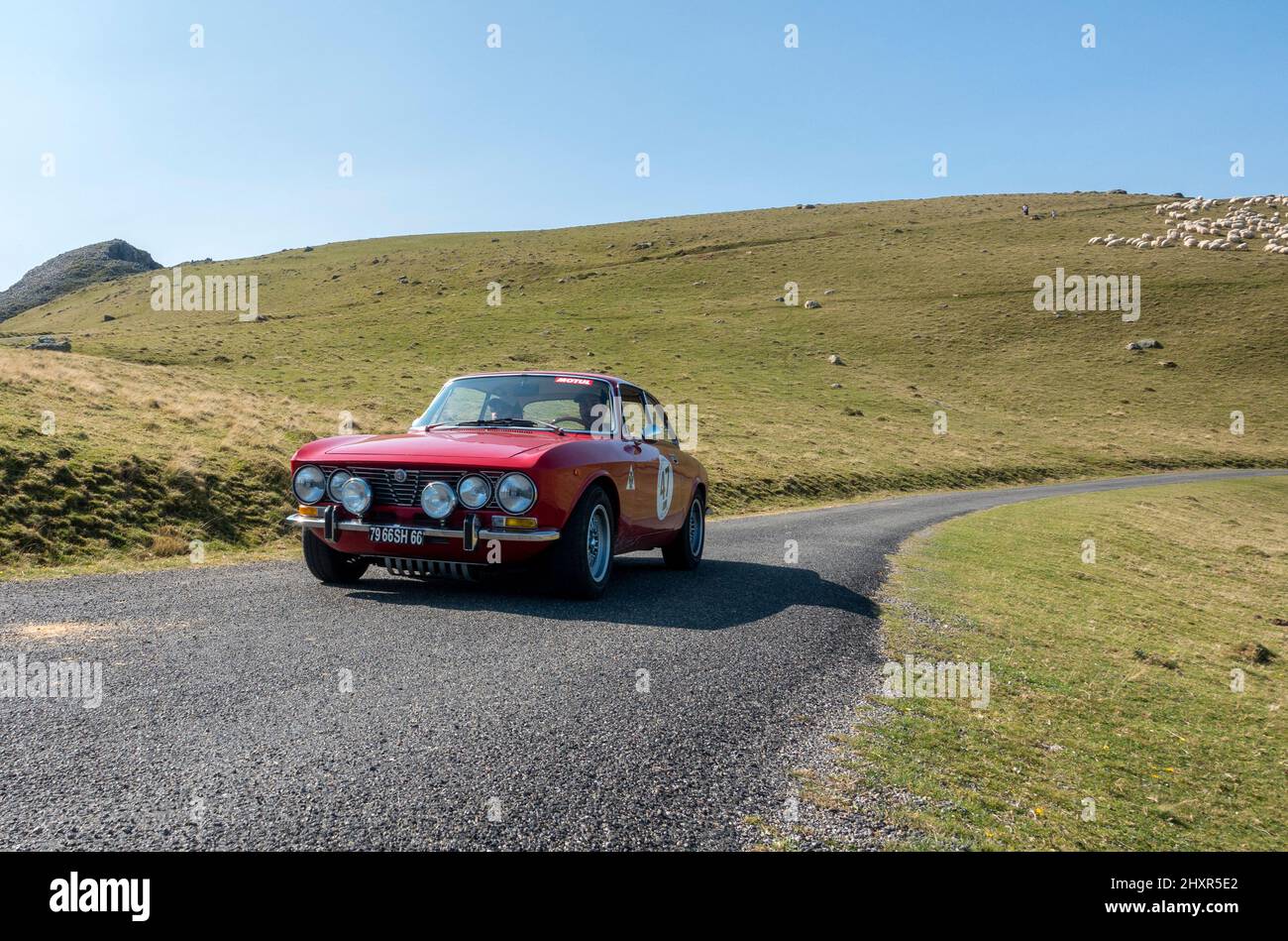 Classic car Alfa Romeo Giulia driving through over the Pyrenees from France to Spain Stock Photo