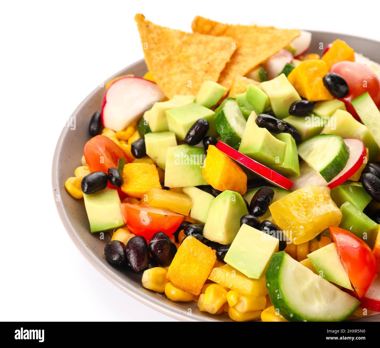 Bowl of tasty Mexican vegetable salad with black beans and radish on