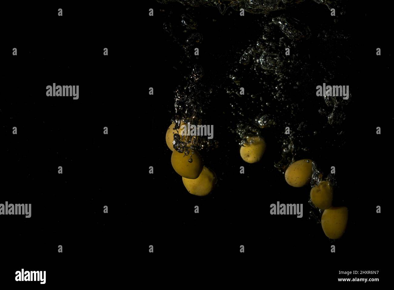 olives in water with splash on black background Stock Photo Alamy