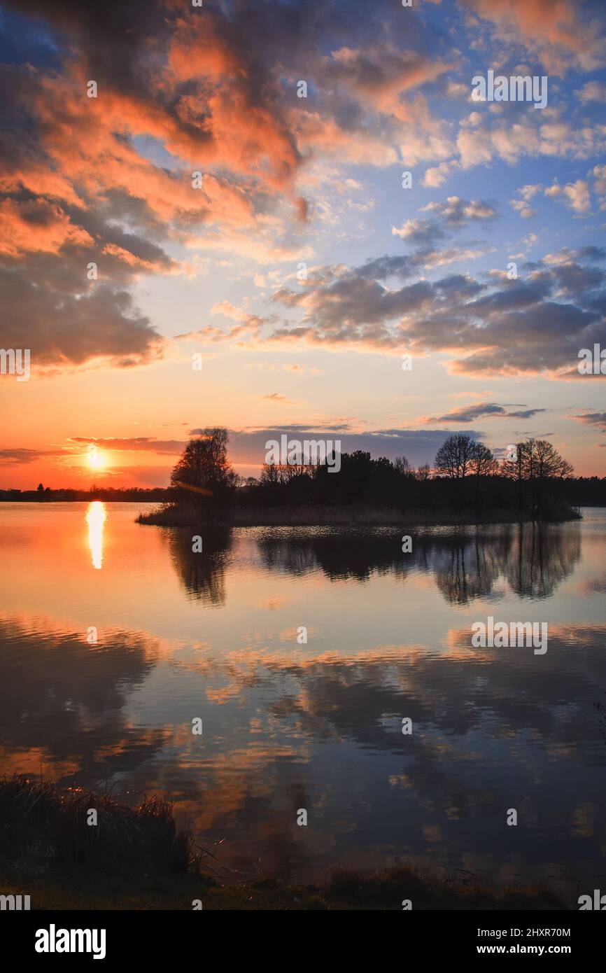Beautiful morning spring landscape. Sunrise over the lake with a beautiful sky. Stock Photo