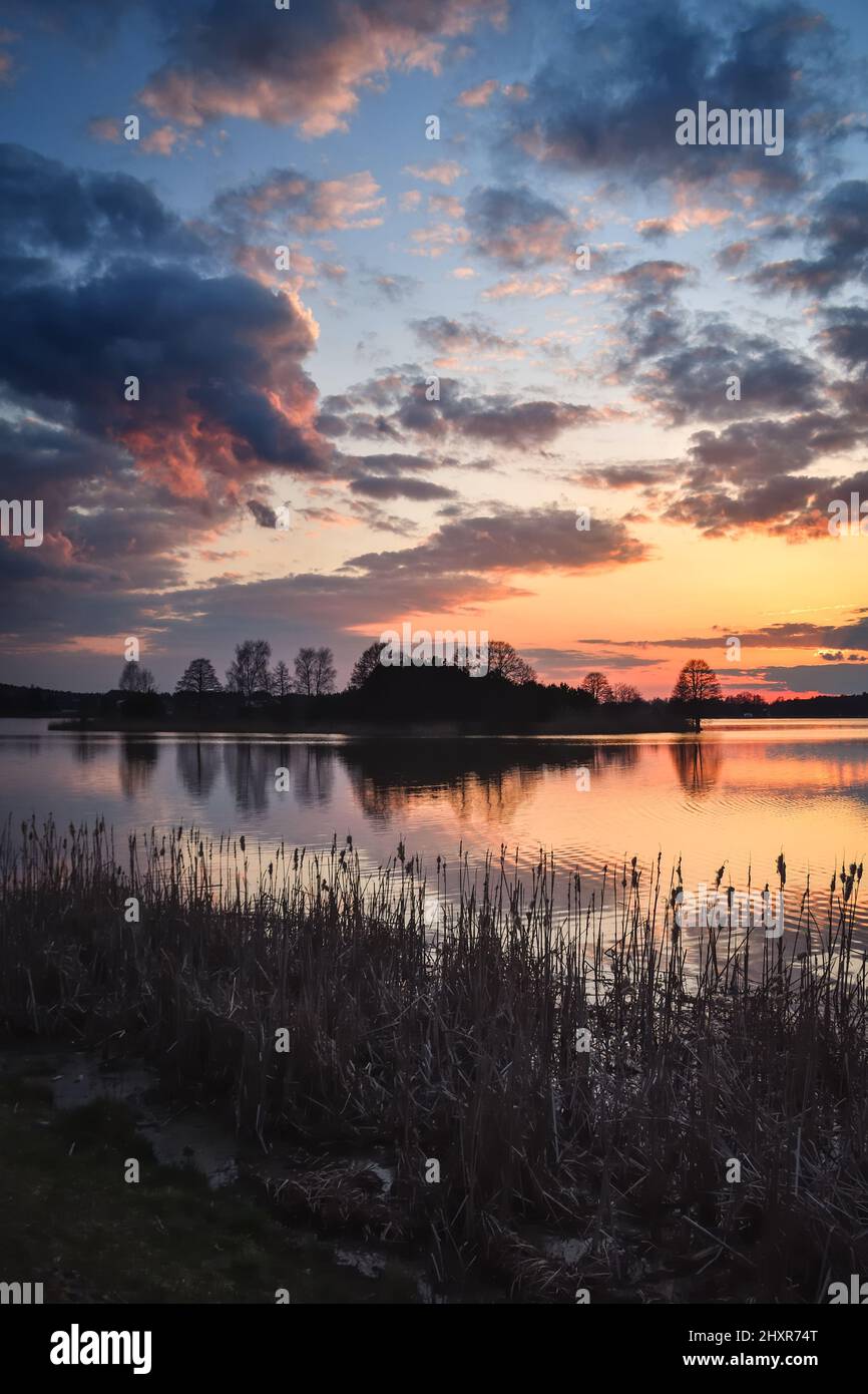 Beautiful morning spring landscape. Sunrise over the lake with a beautiful sky. Stock Photo